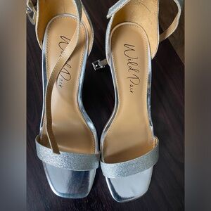 Silver heels brand new with strap around the ankle 8’5 W